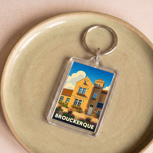 Porte-clés souvenir de la ville de Brouckerque avec une illustration stylisée.