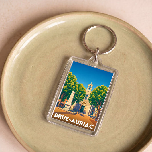 Porte-clés souvenir de la ville de Brue-Auriac avec une illustration stylisée.