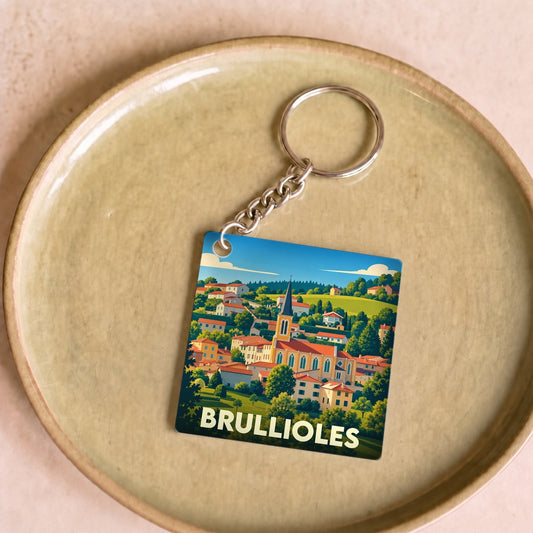 Porte-clés souvenir de la ville de Brullioles avec une illustration stylisée du village.