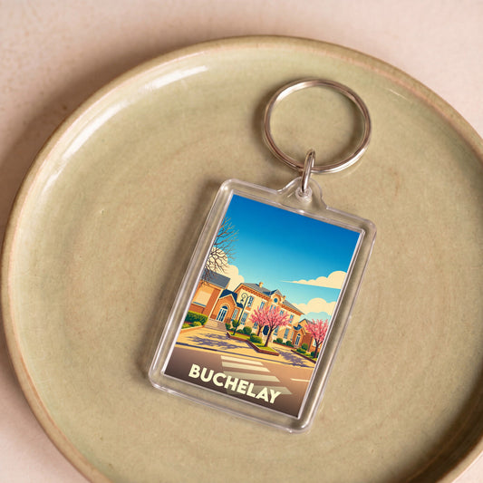 Porte-clés souvenir de la ville de Buchelay avec une illustration stylisée.