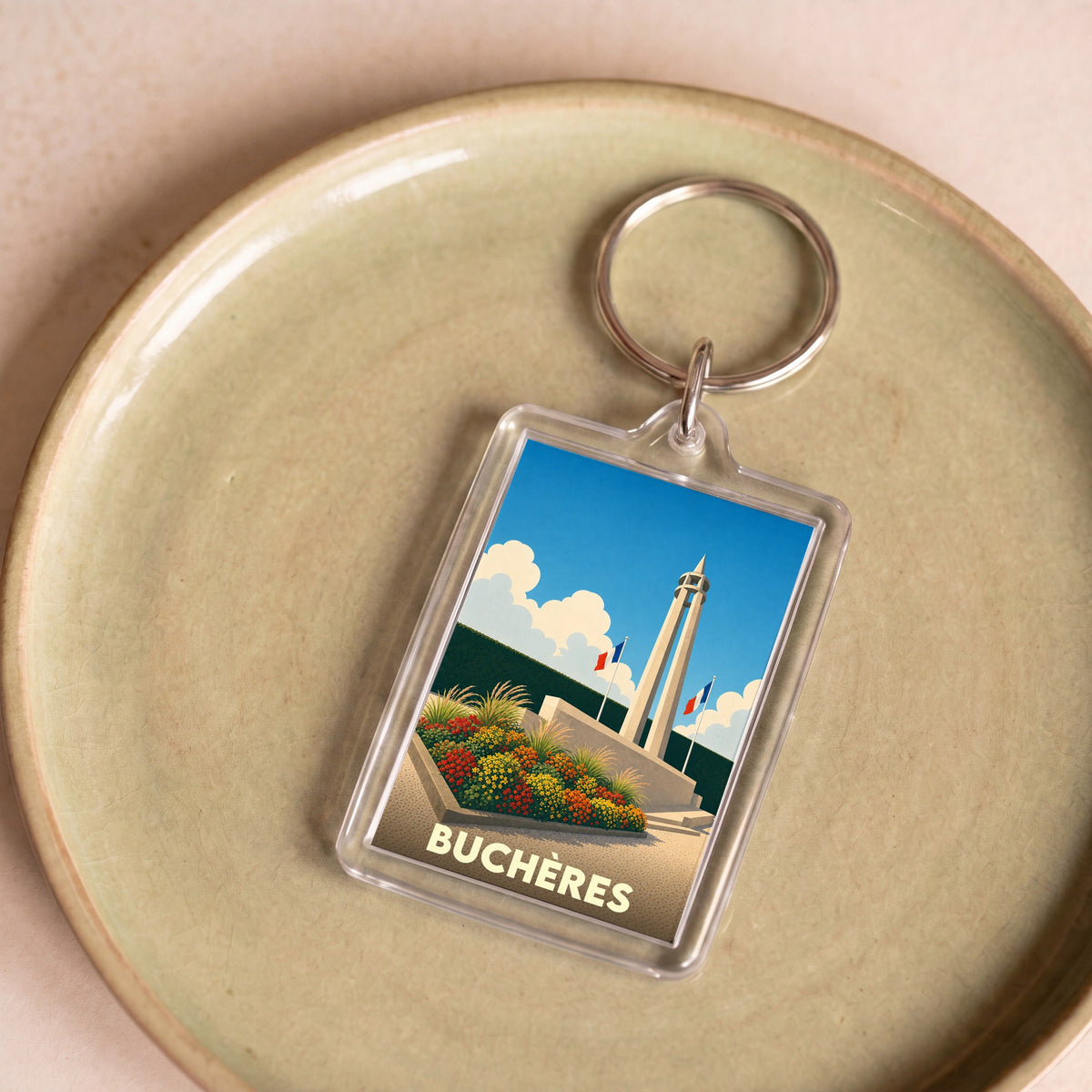 Porte-clés souvenir de la ville de Buchères avec une illustration stylisée de son monument.