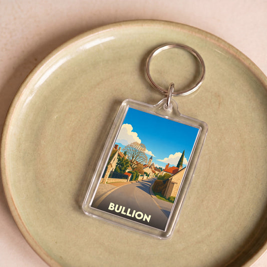 Porte-clés souvenir de la ville de Bullion avec une illustration stylisée d'une rue pittoresque.