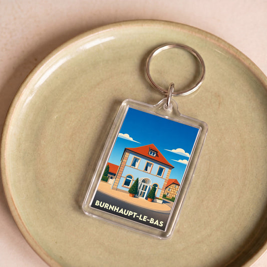 Porte-clés souvenir de la ville de Burnhaupt-le-Bas avec une illustration stylisée.