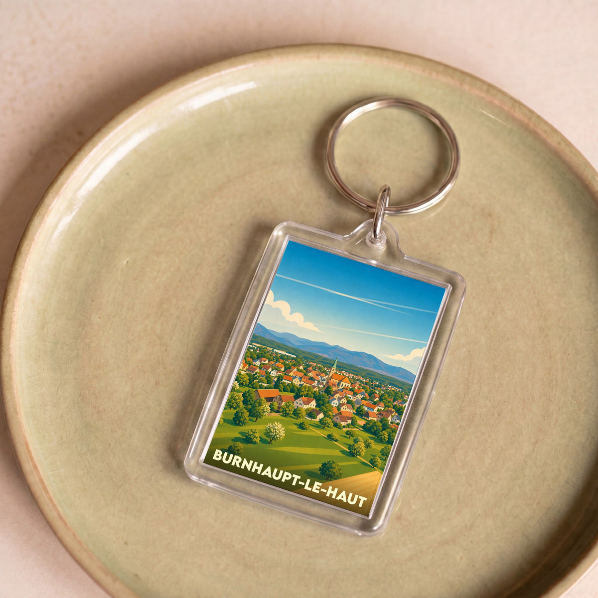 Porte-clés souvenir de la ville de Burnhaupt-le-Haut avec une illustration stylisée.