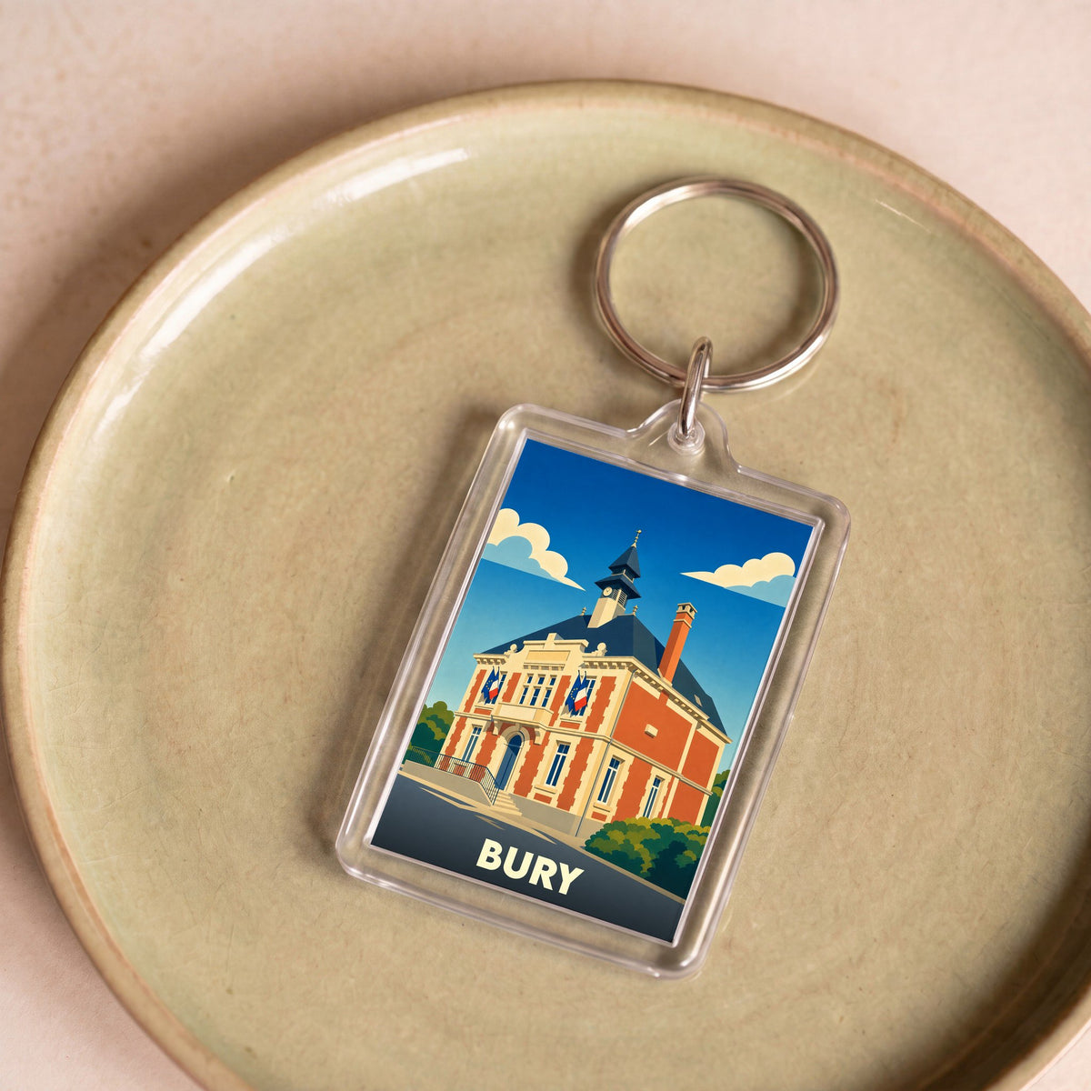 Porte-clés souvenir de la ville de Bury avec une illustration stylisée de son hôtel de ville.