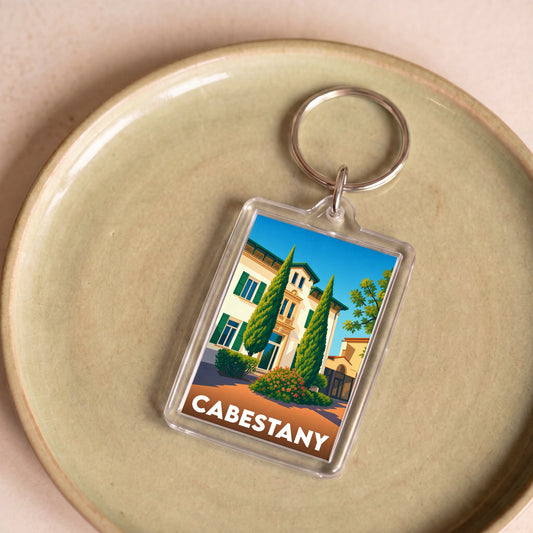 Porte-clés souvenir de la ville de Cabestany avec une illustration stylisée.