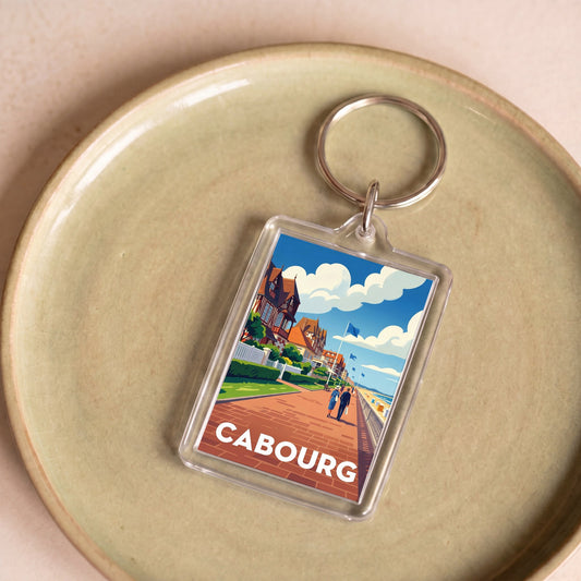 Porte-clés souvenir de la ville de Cabourg avec une illustration stylisée.