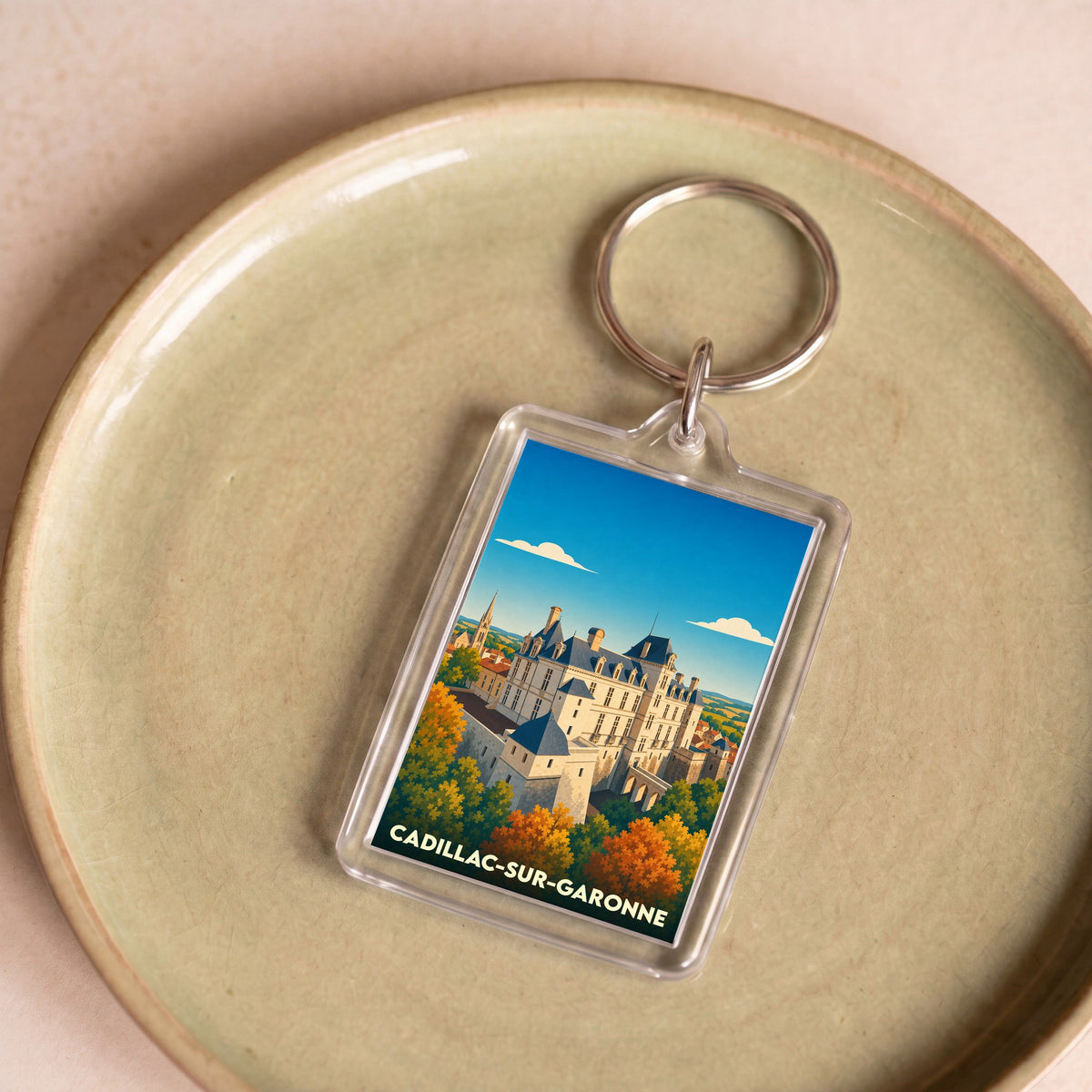 Porte-clés souvenir de la ville de Cadillac-sur-Garonne avec une illustration stylisée de son château.