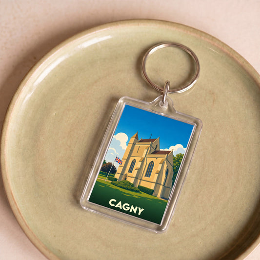 Porte-clés souvenir de la ville de Cagny avec une illustration stylisée d'une église sous un ciel bleu.