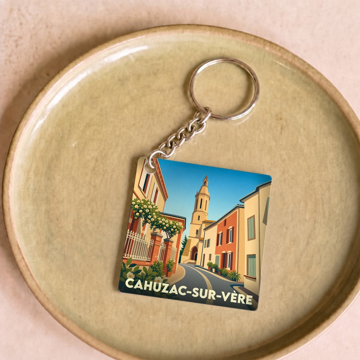 Porte-clés souvenir de la ville de Cahuzac-sur-Vère avec une illustration stylisée.