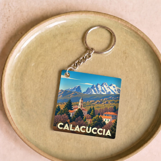 Porte-clés souvenir de la ville de Calacuccia orné d'une illustration stylisée de ses montagnes et de son église.