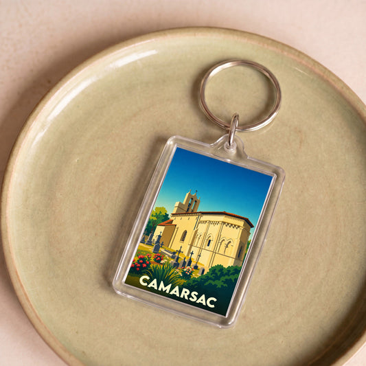 Porte-clés souvenir de la ville de Camarsac avec une illustration stylisée de son église.