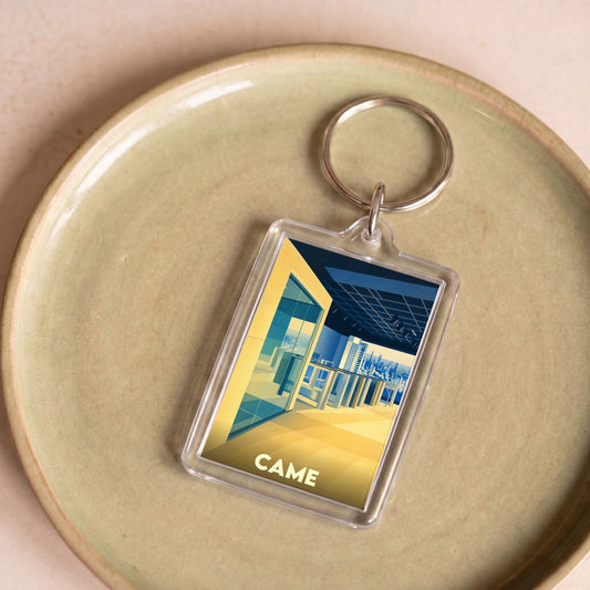 Porte-clés souvenir de la ville de Came avec une illustration urbaine stylisée.
