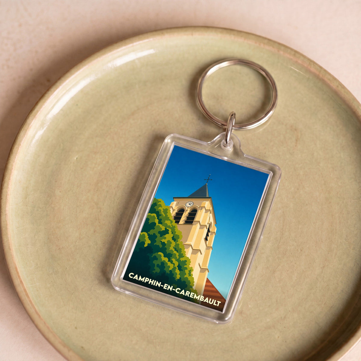 Porte-clés souvenir de la ville de Camphin-en-Carembault avec une illustration stylisée de son église.