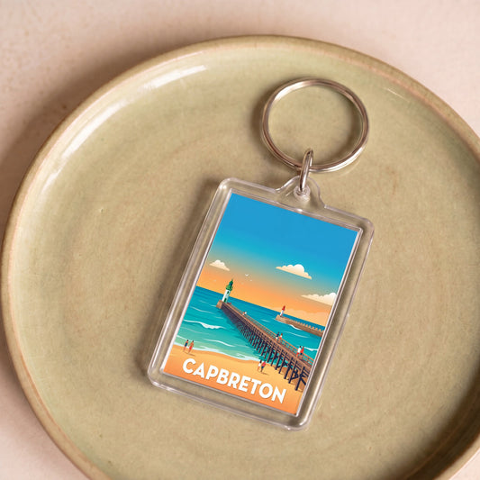 Porte-clés souvenir de la ville de Capbreton avec une illustration stylisée de sa jetée.