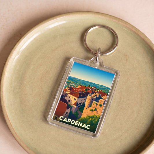 Porte-clés souvenir de la ville de Capdenac avec une illustration stylisée.