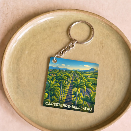 Porte-clés souvenir de la ville de Capesterre-Belle-Eau avec une illustration stylisée d'une allée de palmiers.