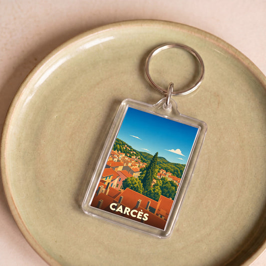 Porte-clés souvenir de la ville de Carcès avec une illustration stylisée de ses toits provençaux.