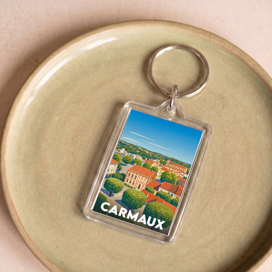 Porte-clés souvenir de la ville de Carmaux avec une illustration stylisée.