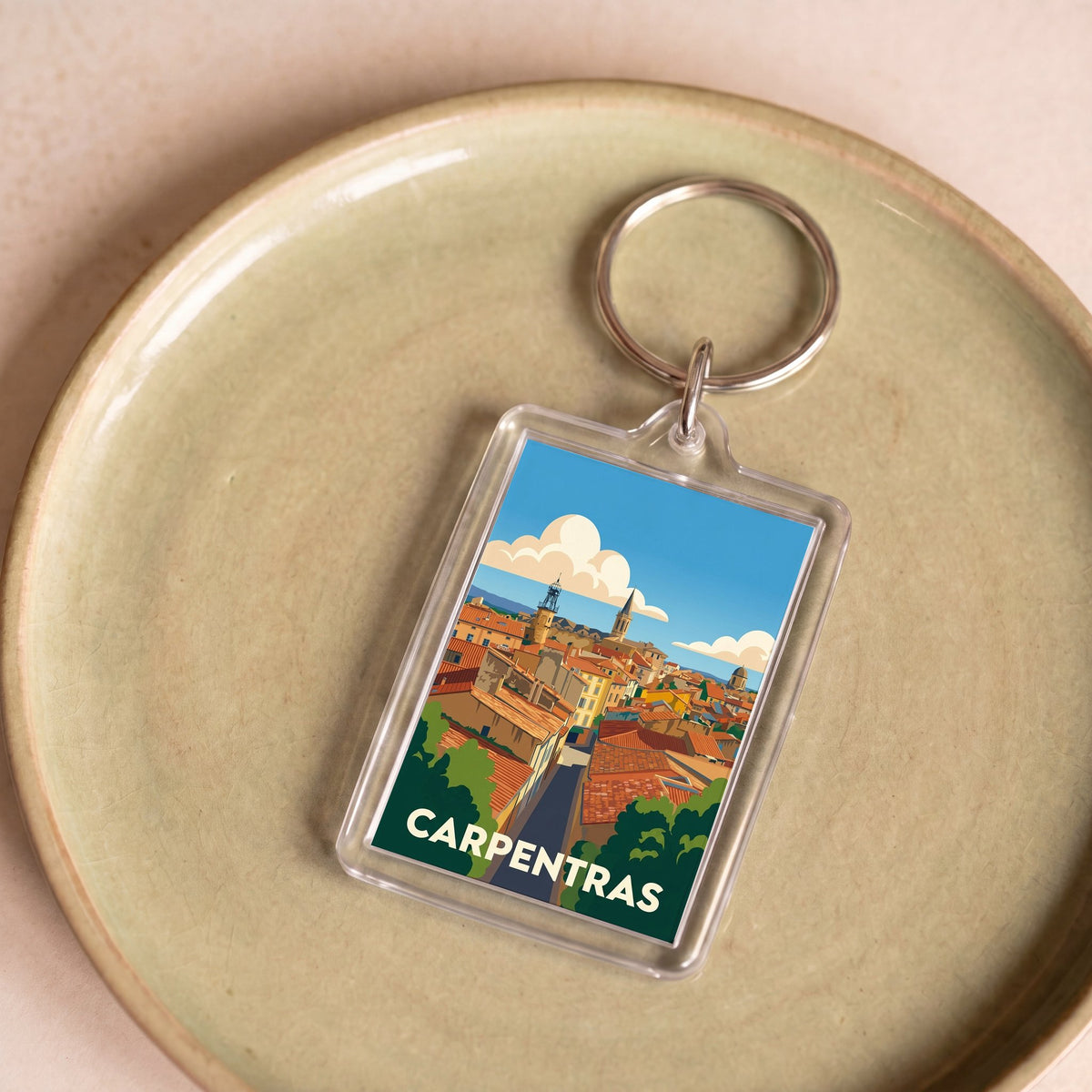 Porte-clés souvenir de la ville de Carpentras avec une illustration stylisée.