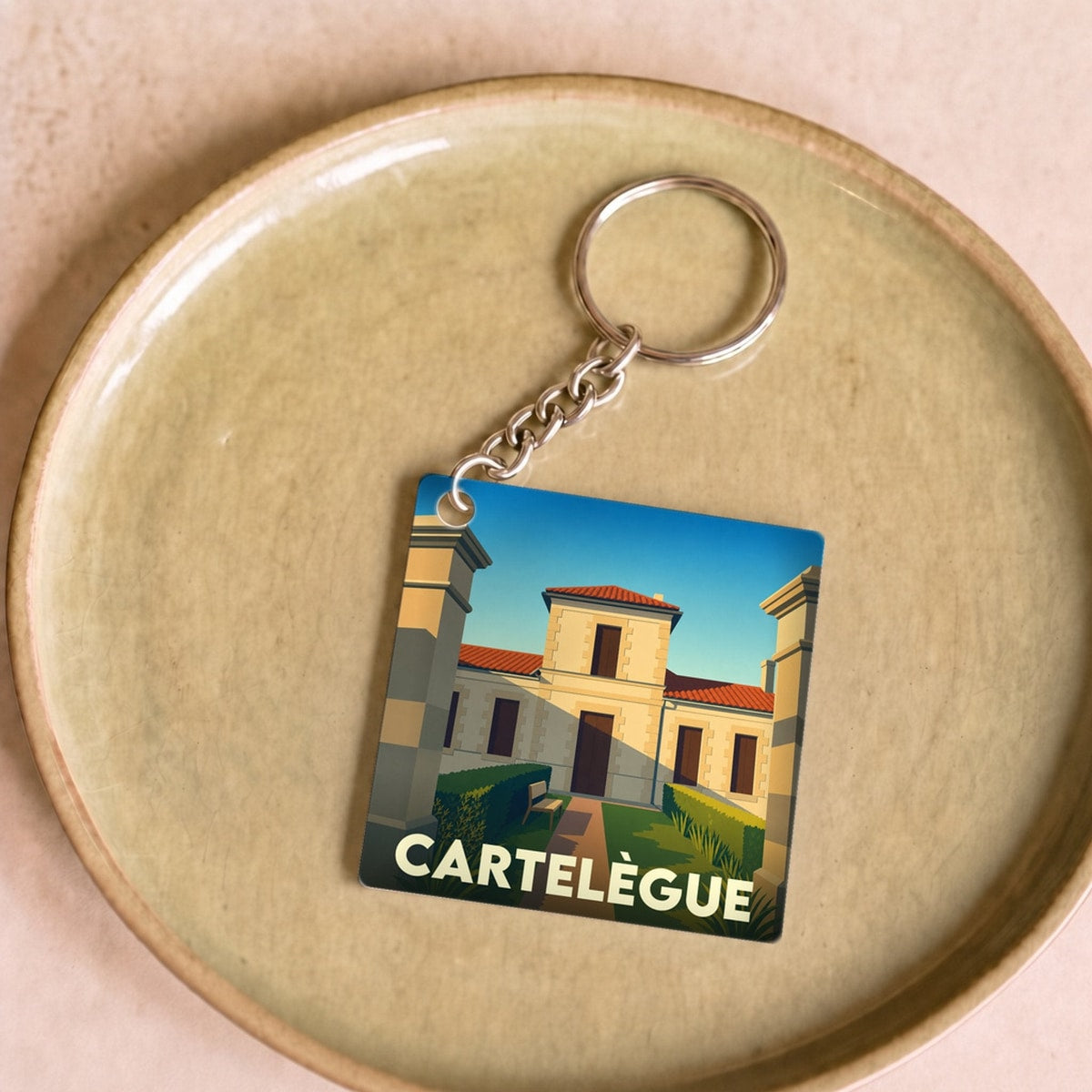 Porte-clés souvenir de la ville de Cartelègue avec une illustration stylisée.