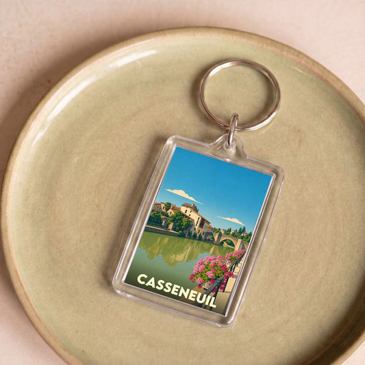 Porte-clés souvenir de la ville de Casseneuil avec une illustration stylisée.