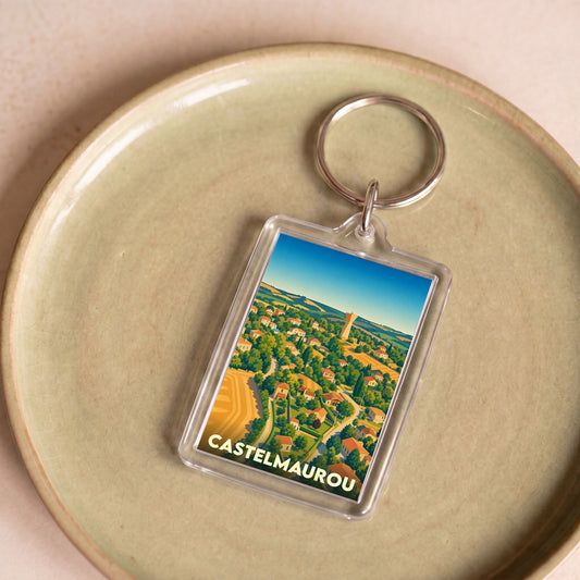Porte-clés souvenir de la ville de Castelmaurou avec une illustration stylisée de ses paysages.