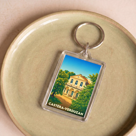 Porte-clés souvenir de la ville de Castéra-Verduzan avec une illustration stylisée d'un bâtiment historique.