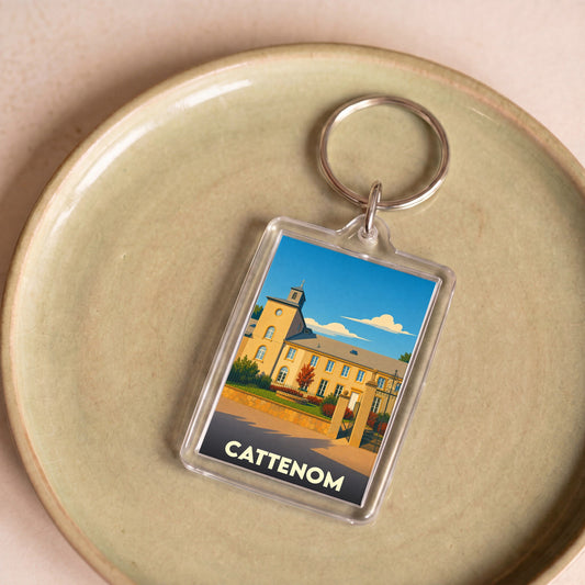 Porte-clés souvenir de la ville de Cattenom avec une illustration stylisée.