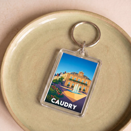 Porte-clés souvenir de la ville de Caudry avec une illustration stylisée.