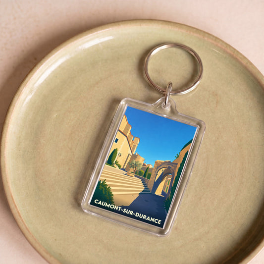 Porte-clés souvenir de la ville de Caumont-sur-Durance avec une illustration stylisée.