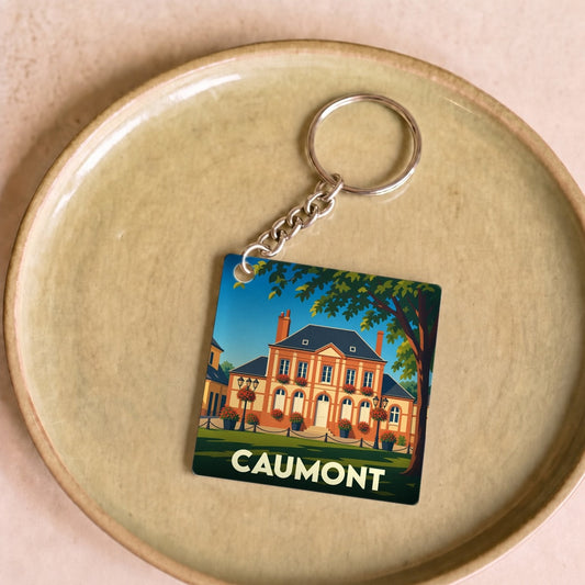 Porte-clés souvenir de la ville de Caumont avec une illustration stylisée de l'Hôtel de Caumont.