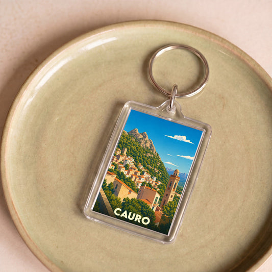 Porte-clés souvenir de la ville de Cauro avec une illustration stylisée.