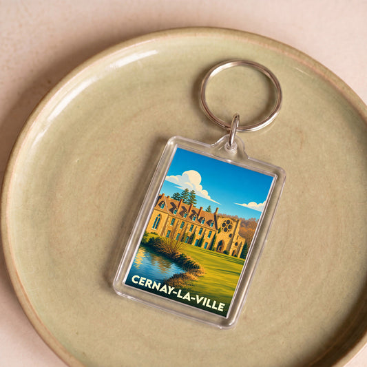 Porte-clés souvenir de la ville de Cernay-la-Ville avec une illustration stylisée de son abbaye.