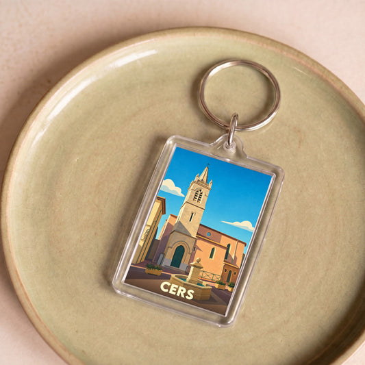 Porte-clés souvenir de la ville de Cers avec une illustration stylisée de son église.