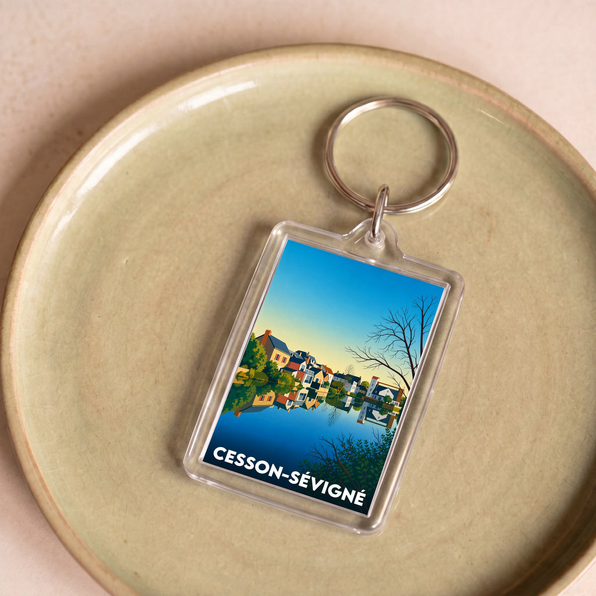 Porte-clés souvenir de la ville de Cesson-Sévigné avec une illustration stylisée.