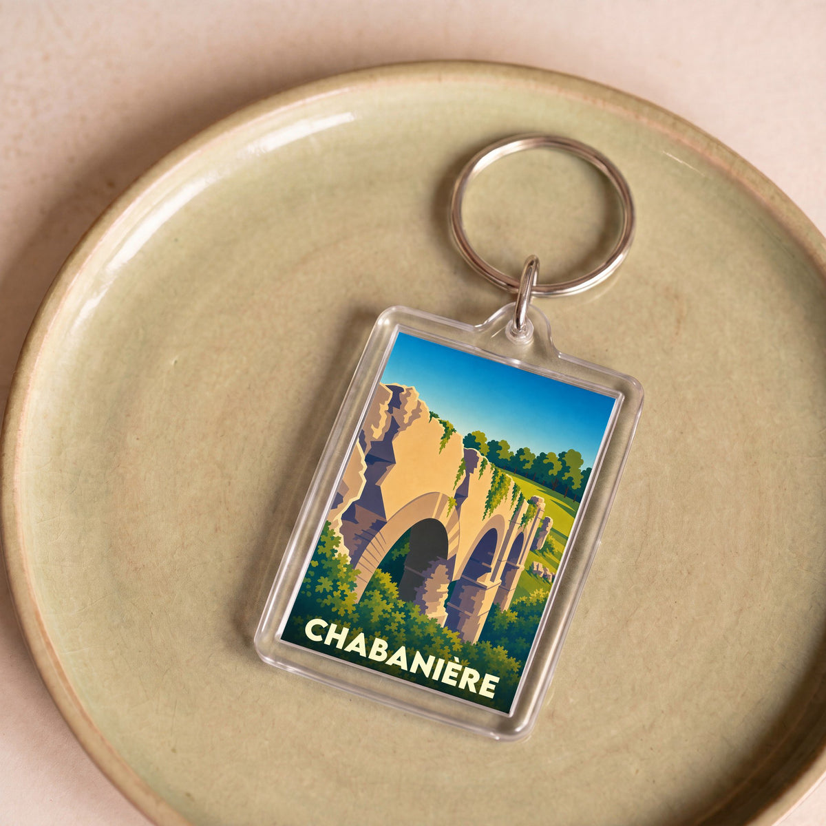 Porte-clés souvenir de la ville de Chabanière avec une illustration stylisée d'un aqueduc romain.