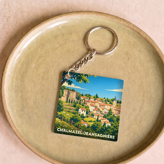 Porte-clés souvenir de la ville de Chalmazel-Jeansagnière avec une illustration stylisée du village et de son château.