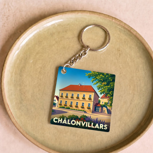 Porte-clés souvenir de la ville de Châlonvillars avec une illustration stylisée.