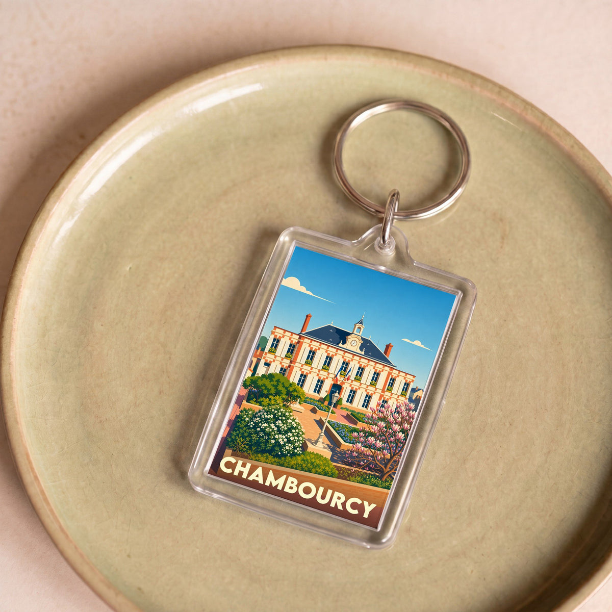 Porte-clés souvenir de la ville de Chambourcy avec une illustration stylisée de son hôtel de ville.