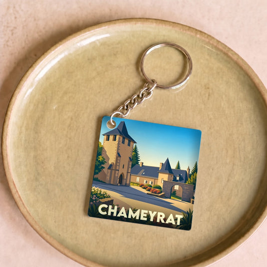 Porte-clés souvenir de la ville de Chameyrat avec une illustration stylisée d'un château.