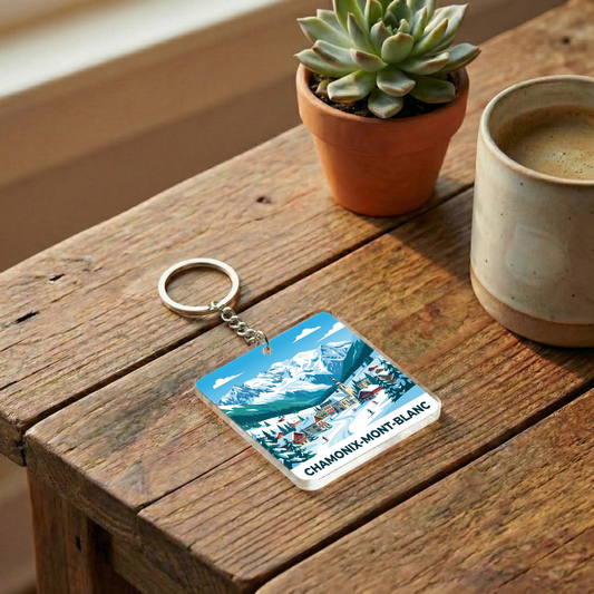Porte-clés souvenir de la ville de Chamonix-Mont-Blanc avec une illustration stylisée de montagne.