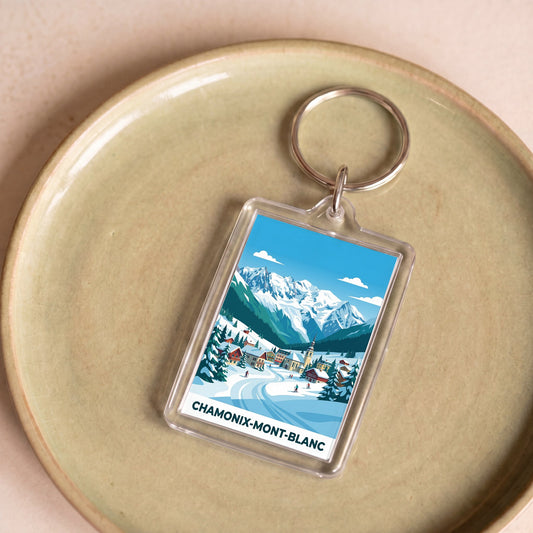 Porte-clés souvenir de la ville de Chamonix-Mont-Blanc avec une illustration stylisée de montagne.