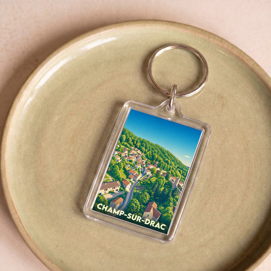Porte-clés souvenir de la ville de Champ-sur-Drac avec une illustration stylisée.
