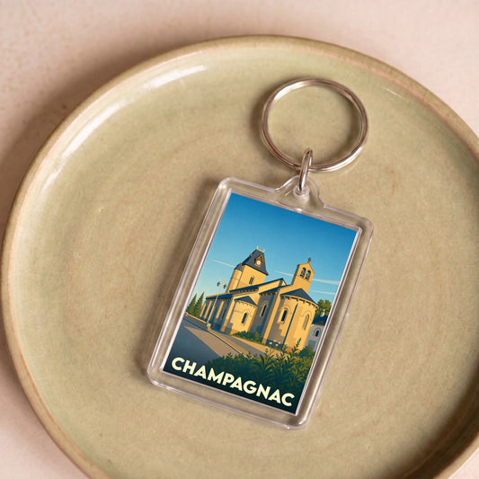 Porte-clés souvenir de la ville de Champagnac avec une illustration stylisée de son église.
