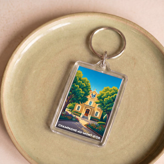 Porte-clés souvenir de la ville de Champagne-au-Mont-d'Or avec une illustration colorée et stylisée.