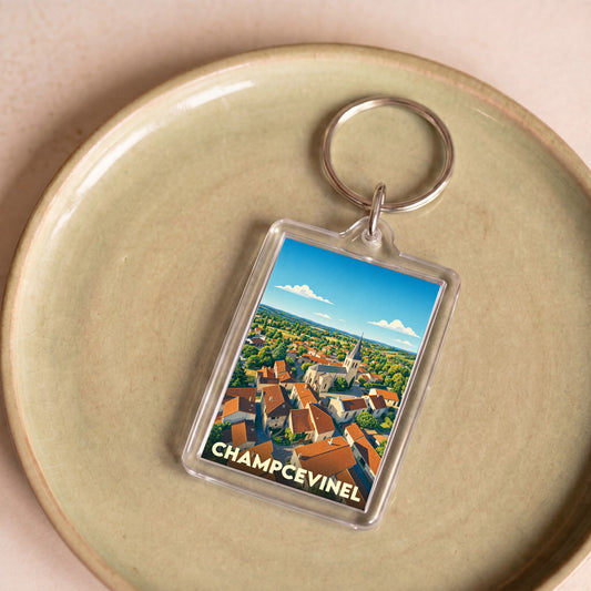 Porte-clés souvenir de la ville de Champcevinel avec une illustration stylisée.