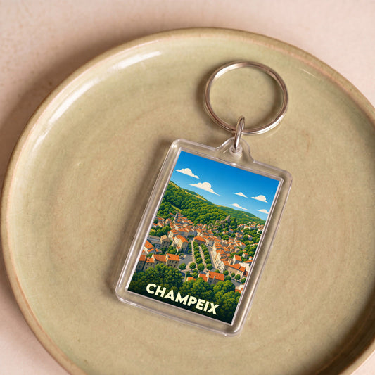 Porte-clés souvenir de la ville de Champeix avec une illustration stylisée.