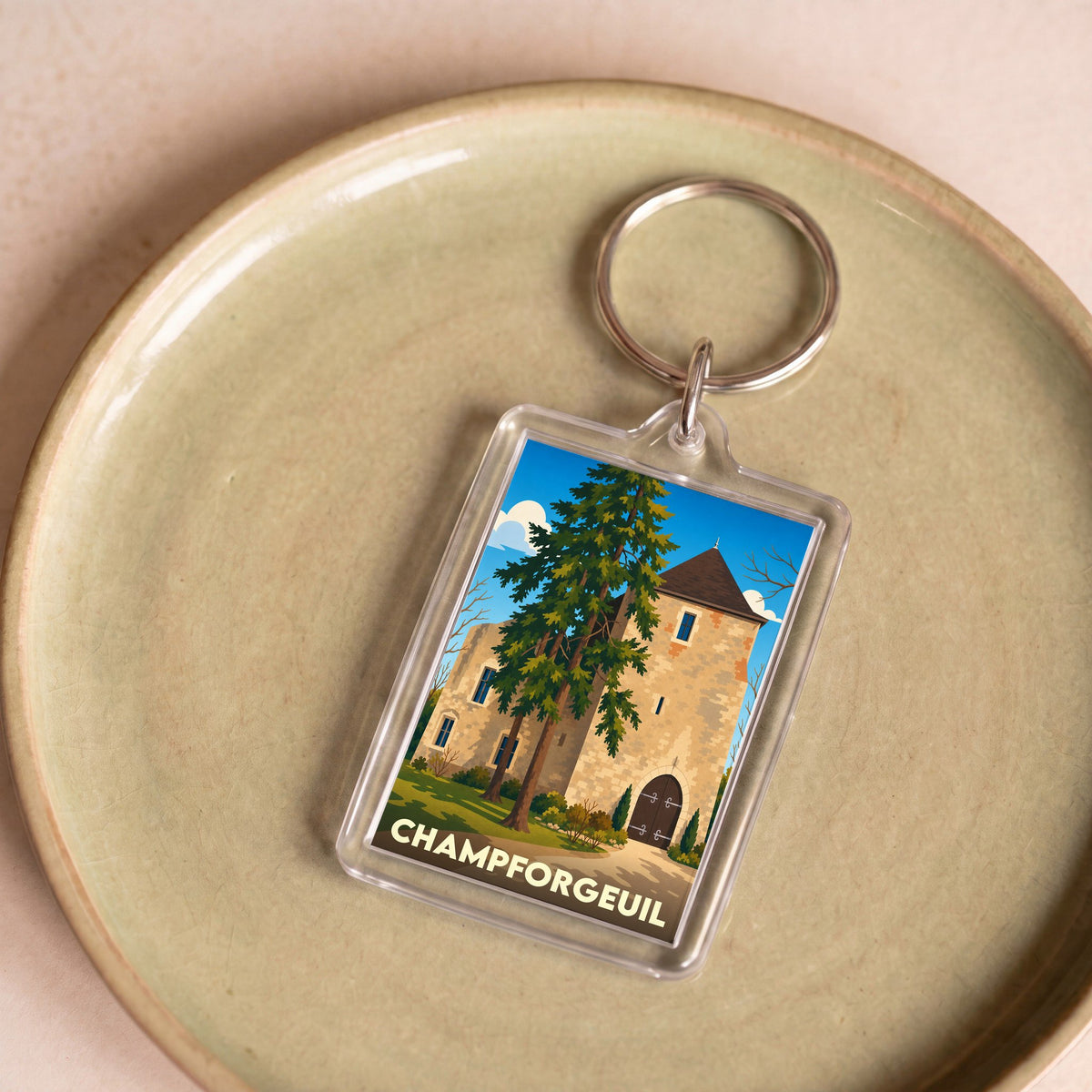 Porte-clés souvenir de la ville de Champforgeuil avec une illustration stylisée de son patrimoine.