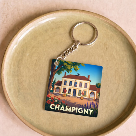 Porte-clés souvenir de la ville de Champigny avec une illustration stylisée d'une maison de maître.